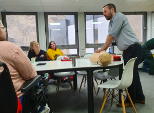 Participants instruct Ed on how to give CPR